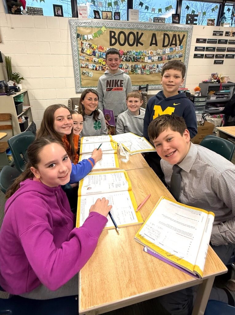 Tecumseh Middle School teacher Carrie Barden is pictured with several of her fifth-grade students — clockwise from lower left, Kaylee Engels, Isla Kelly, Leyton Stephenson, Garrison Jones, Landon Dozier, Drew D’Amico, and Gybson Barker. (Photo by Renee Lapham Collins)