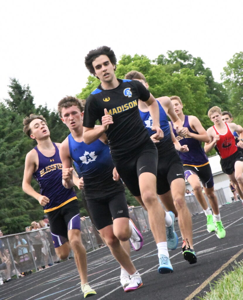 Madison’s Trenton Fetter takes the lead in the boys 1,600-meter run during the Lenawee County track and field meet on May 26 at Sand Creek. Fetter won both the 1,600-meter and the 800-meter event.