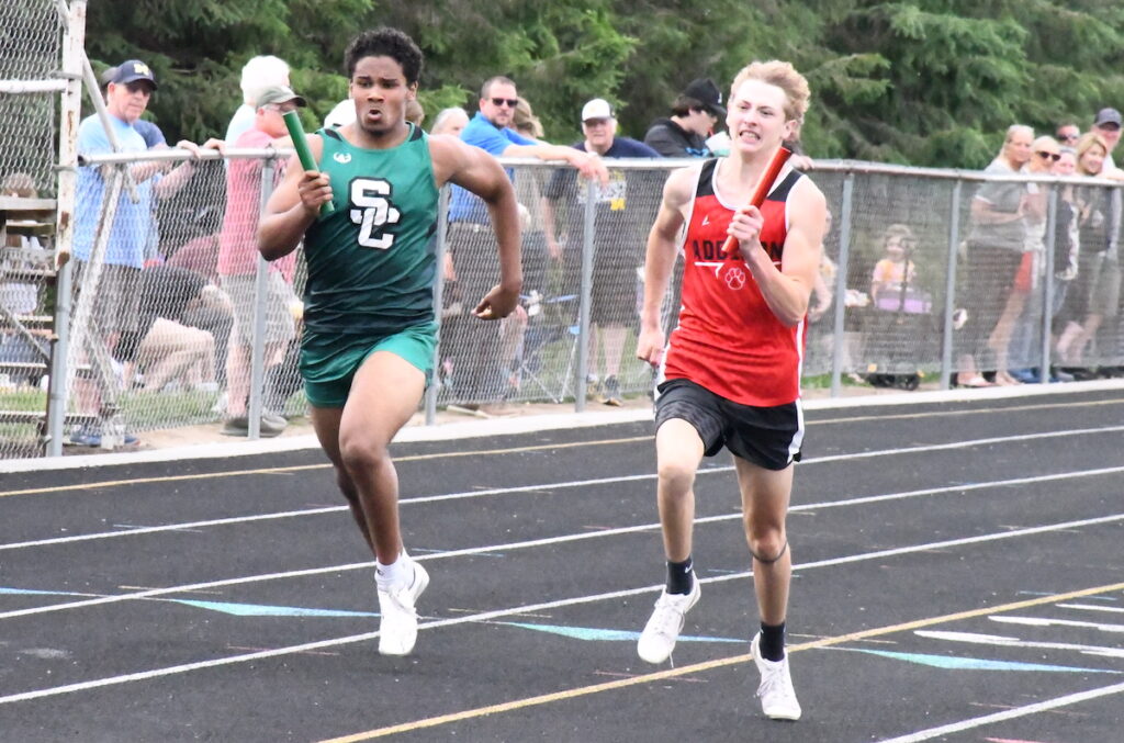 Noah Walters (Sand Creek) and Austin Wilson (Addison) run in the boys 400-meter relay during the Lenawee County All-County Track and Field Meet, which took place on May 26 at Sand Creek. The meet was the final big test for many Lenawee County teams before the MHSAA finals.