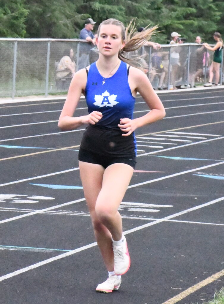 Adrian’s Karina Mihai-Grammes runs in the 3,200-meter event.