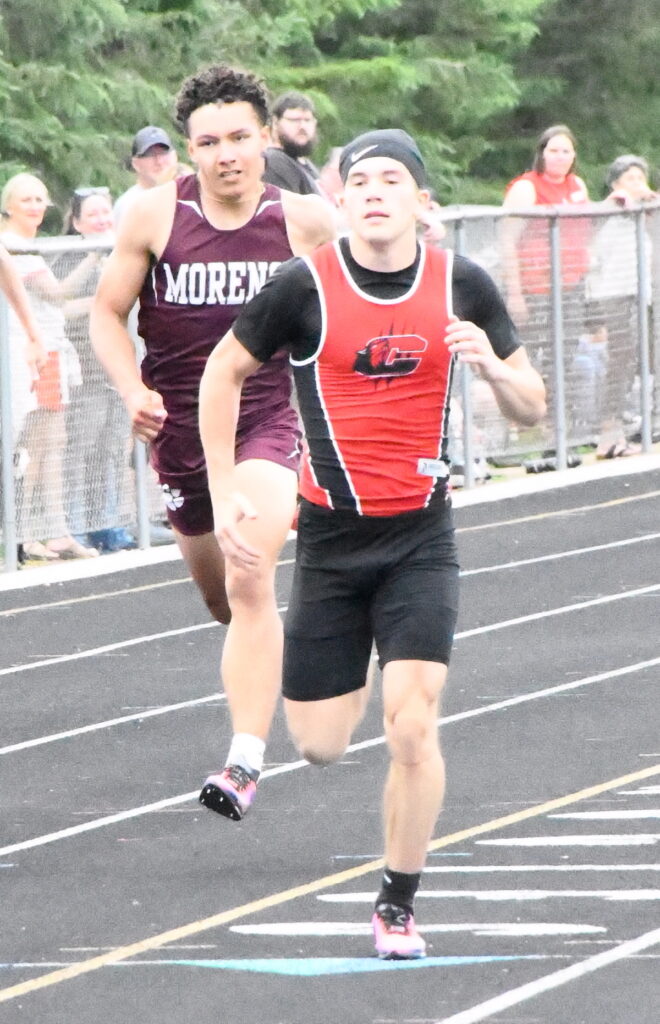 Wyatt Dehring (Clinton) leads Kylan Lester (Morenci) in the 200-meter dash.
