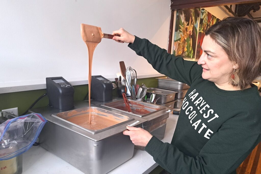Elizabeth Gentry works with a batch of chocolate at Harvest Chocolate. She and her husband make all the chocolate on site, from roasting the beans to the finished product. (Photo by Arlene Bachanov)