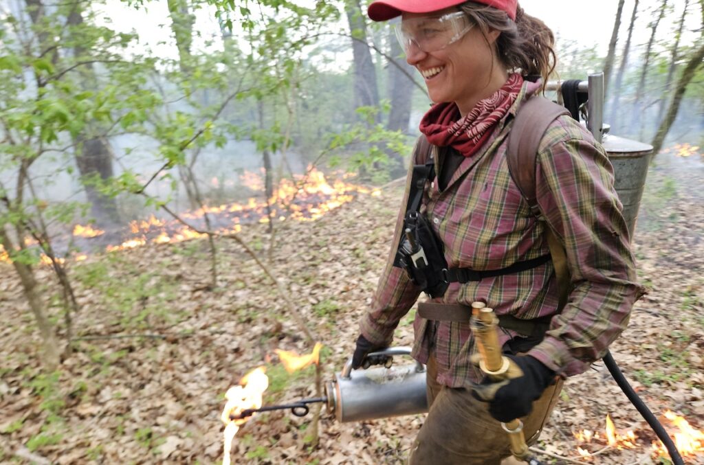 Anna Snoeyink draws a line of fire using a drip torch at a prescribed burn on April 21 near Adrian. (Photos by Kadi Franson)