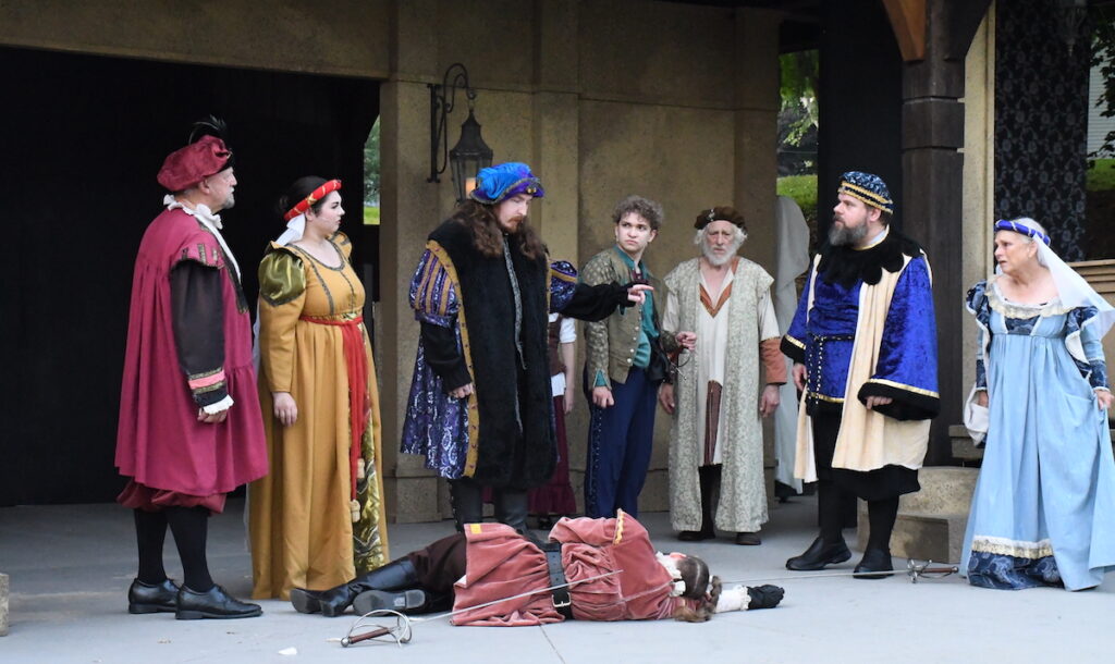 Gathered around the slain body of Kyler Mattoon as Tybalt are Bryan Shane and Cassidy Giddens as Lord and Lady Capulet, Justin Kohlruss as Prince Escalus, AJ Landingham as Benvolio, Mark Schersten as the Prologue, and Rob Flumignan and Pam Adair as Lord and Lady Capulet.