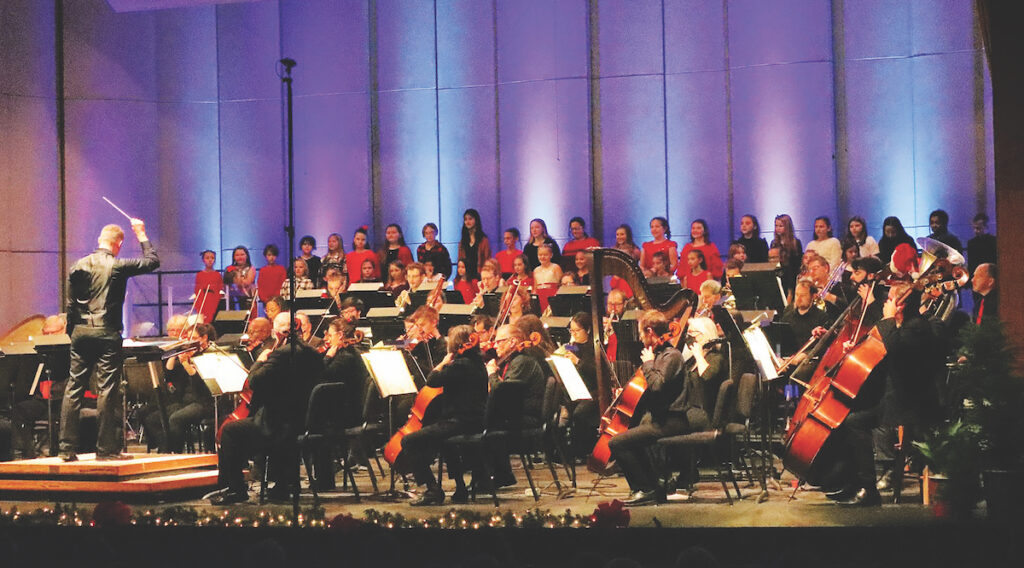 The Clinton Honors Youth Chorus performs with the Adrian Symphony Orchestra during last year’s holiday concert. (Photo by DeAnna Strand/Adrian Symphony Orchestra)