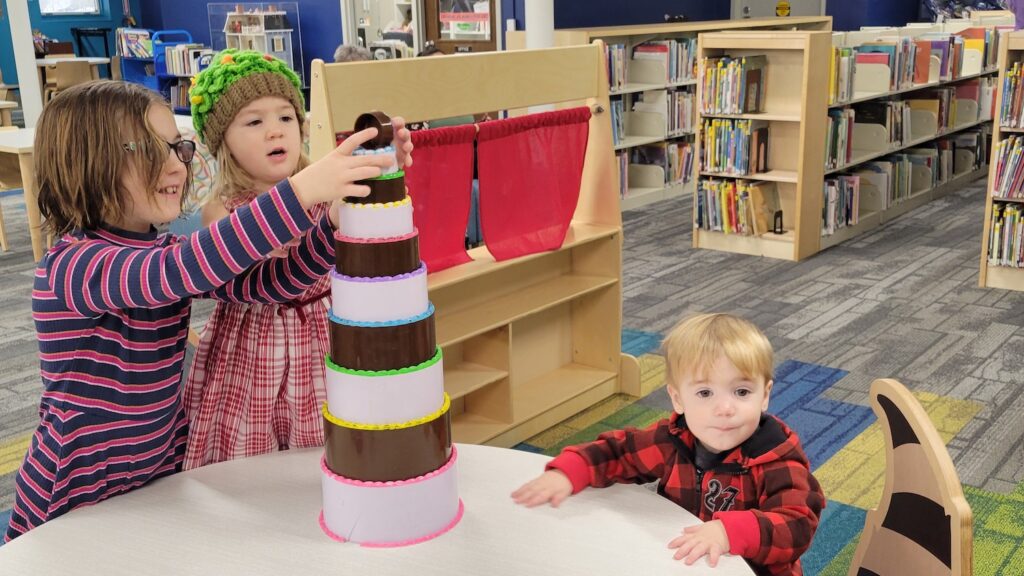 Abigail Goldsmith, 8, and her younger siblings Mariam, 3, and Archer, 1, are pictured in the play area at the Adrian District Library.