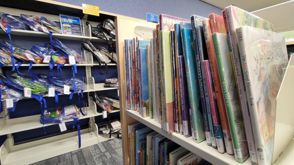 The picture book area in the Adrian District Library youth services department, with STEM backpacks in the background.