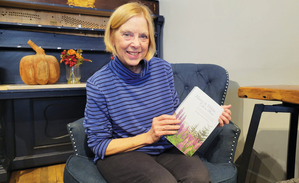 Jennifer Hamlin Church holds a copy of her book, “Harry & Hilda: Letters Home,” during an interview at The Buzz in downtown Adrian.