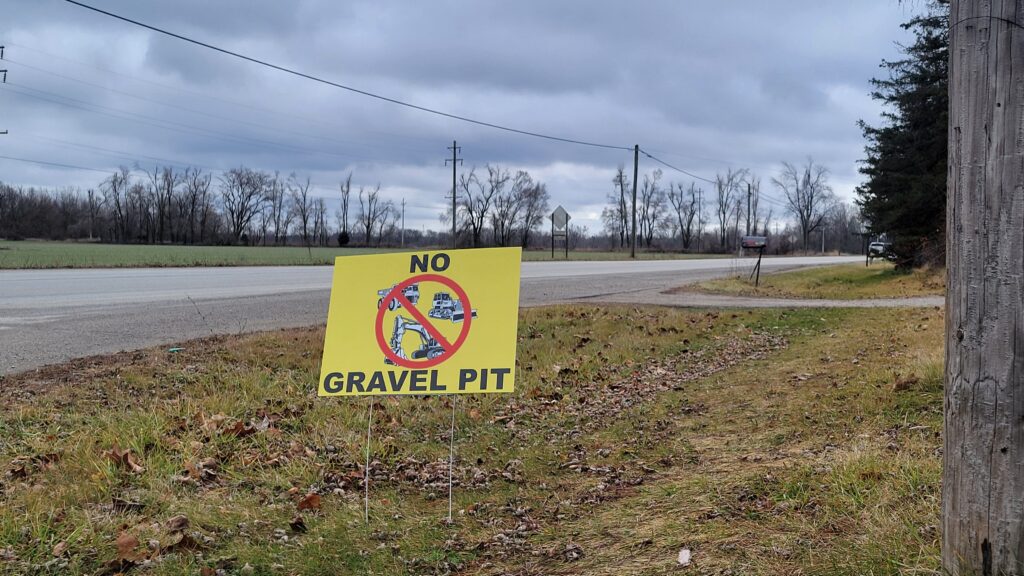 A yard sign at the corner of Occidental Highway and Gady Road urges opposition to a proposed gravel mine nearby.