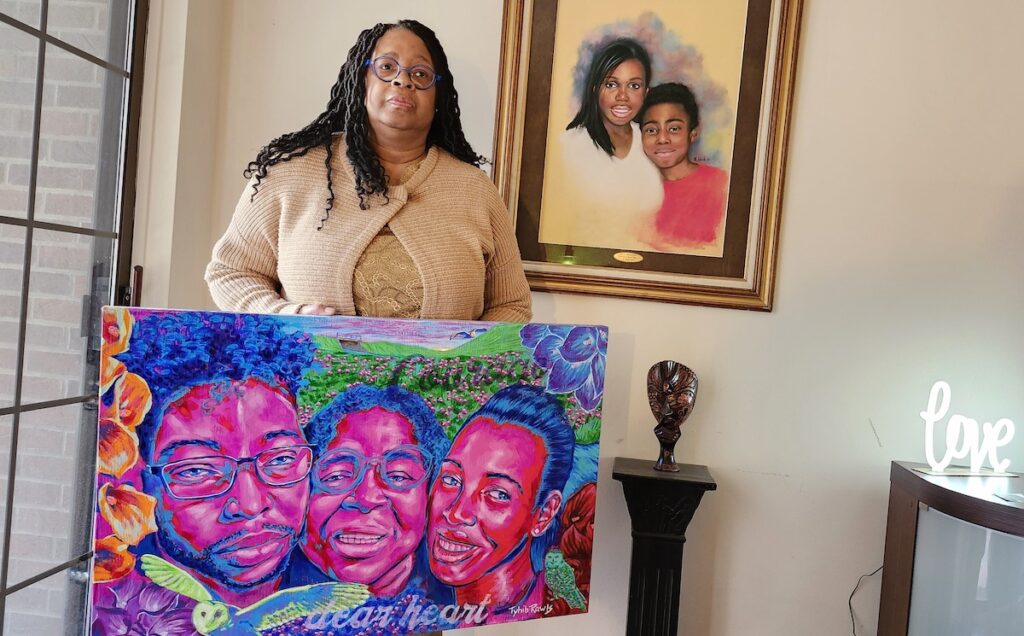 Kimberley Davis stands with portraits of her children, Mariama Walters and John Amara Walters, both Adrian High School alumni who died in young adulthood due to sickle cell disease. Davis is working to raise awareness and direct more resources to fighting the condition, which is underfunded relative to comparable illnesses.