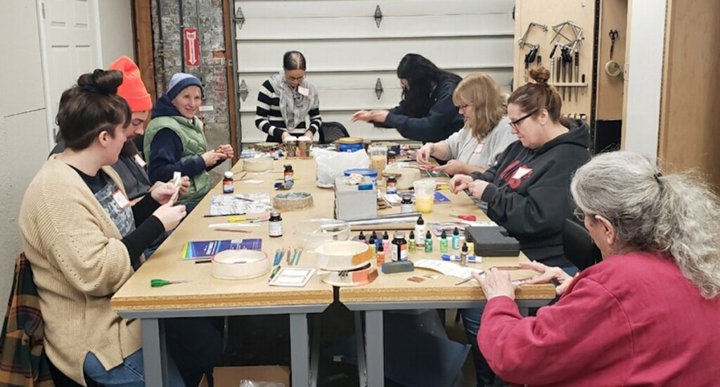 Students work on a mixed-media project involving both the ceramics and metalworking studios during a recent class at the Adrian Center for the Arts.