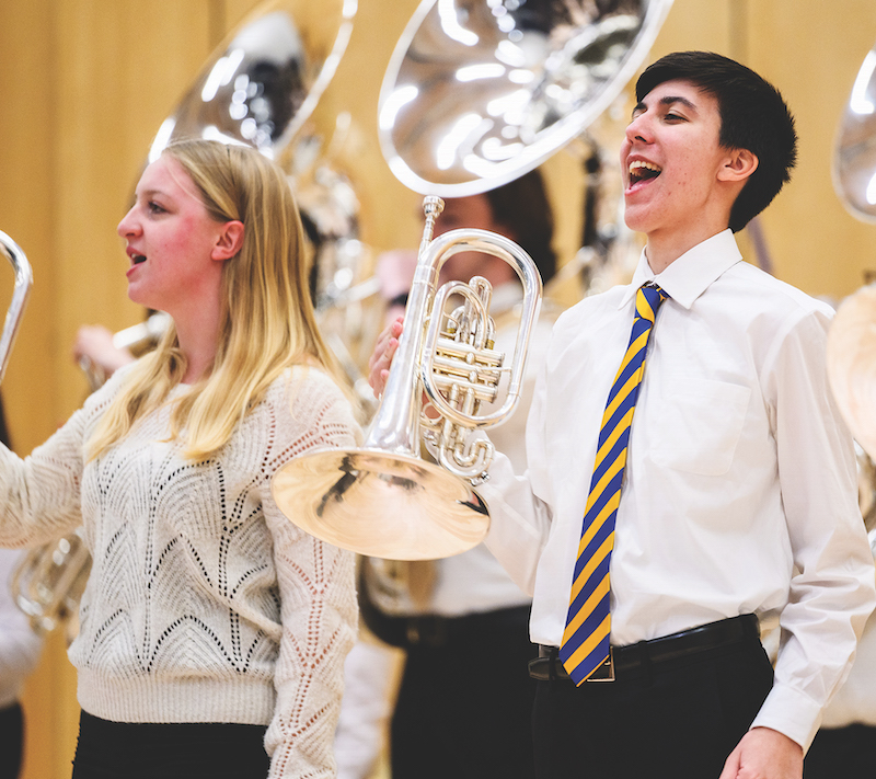 Morgan Andrews and Everett Hanley, both members of the Siena Heights University brass ensemble, perform during the inauguration of Douglas Palmer as the university’s 11th president on March 15.