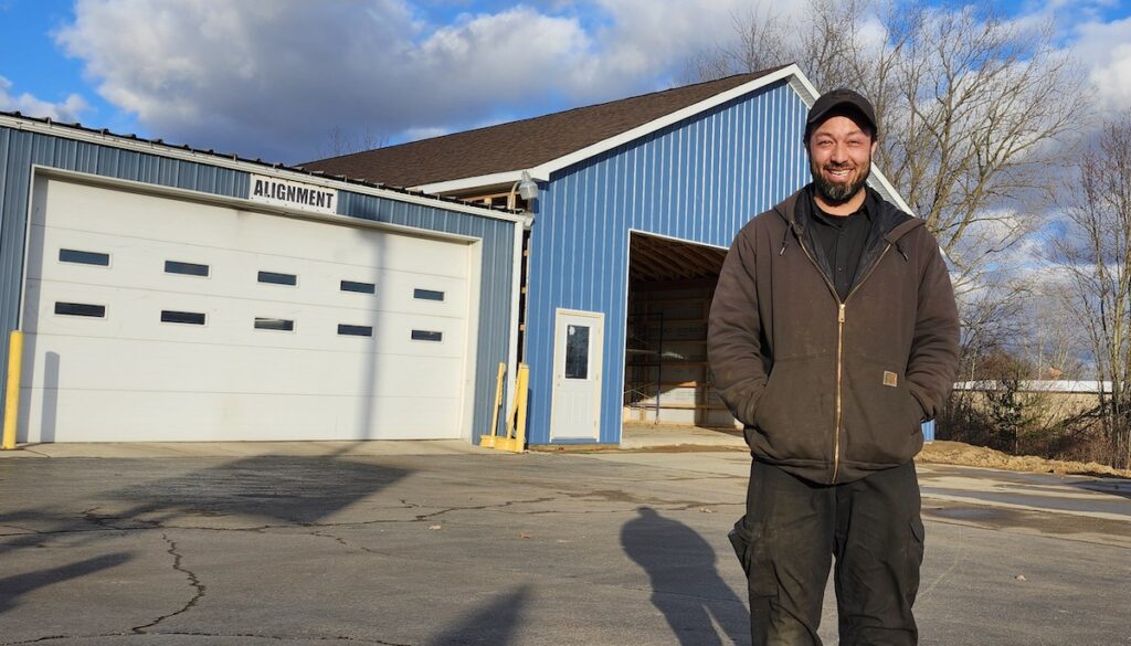 Tony Martinez Jr. is pictured in front of the new building being erected at Tire Outlet Plus on U.S. 223. Martinez manages the store, which is owned by his parents, Tony and Irene Martinez. The family also owns Vulcan Tire, which they opened in 1986.
