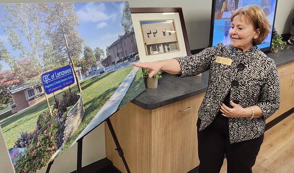 Roxanne Meeks, executive director of the Care Pregnancy Center, shows plans for how the center’s Broad Street building and a house it is renovating on Front Street will become a single campus, with women’s health care in one building and family support in the other.