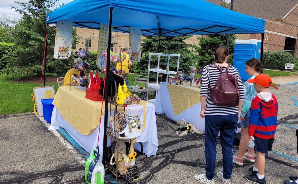 Visitors browse one of the displays at last year’s Bee Day Festival. The annual event, organized by the River Raisin Beekeepers Club, will take place on May 18 at St. John’s Lutheran Church.