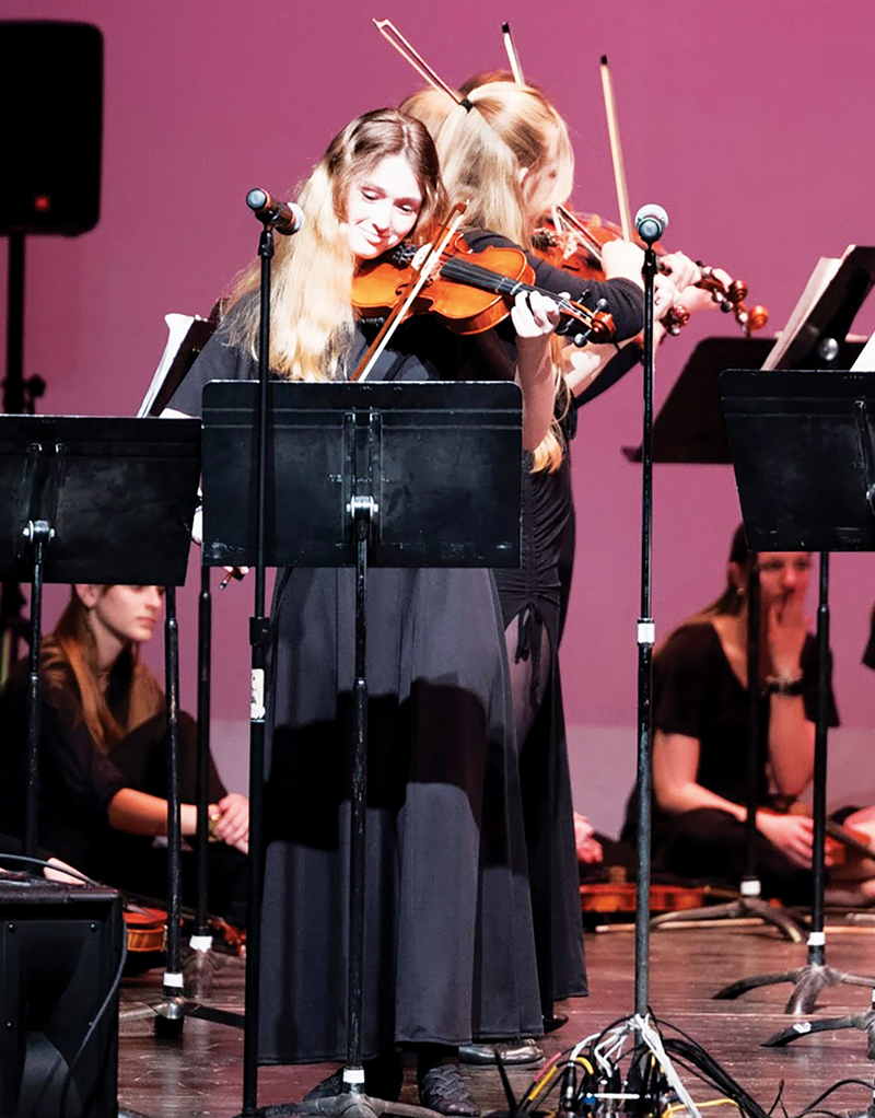 Tecumseh High School student Olivia Adams takes part in a joint concert between the Tecumseh Schools Orchestra and the band Kittel & Co. in April.