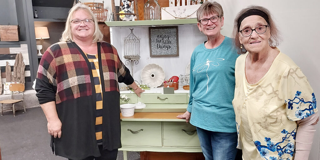 Tammy Dailey, Crystal Wormuth and Judy Love are pictured at Repurposed and More in downtown Tecumseh.