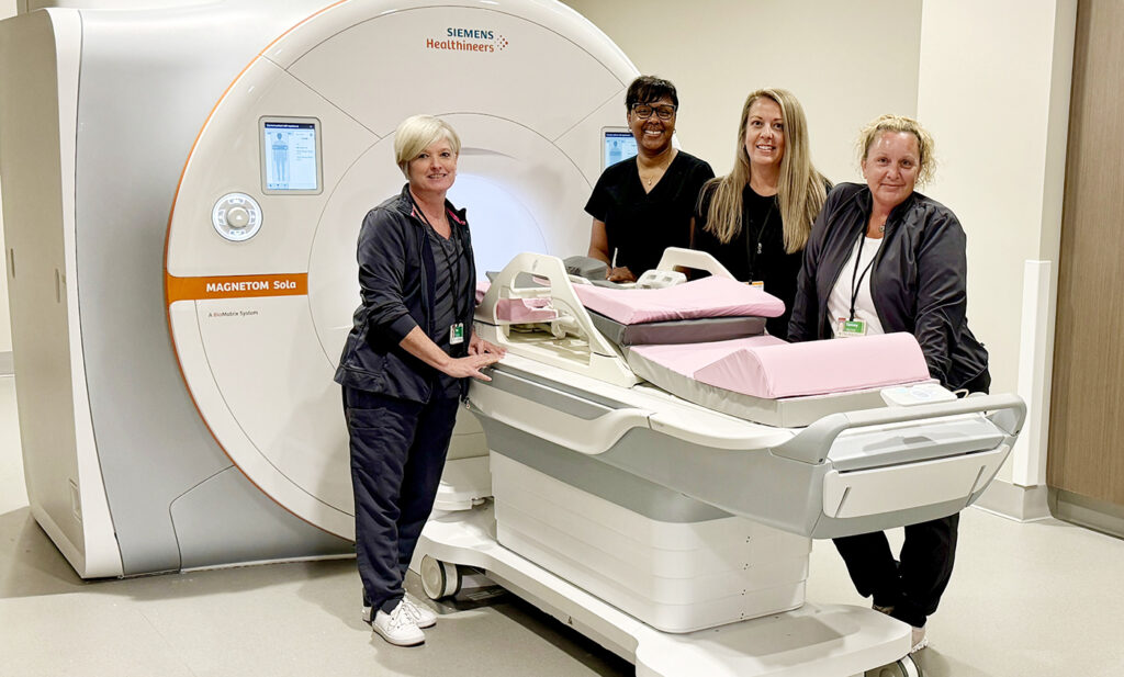 Members of the Hickman Hospital radiology team — Kim Seel, Kamika Ward (applications specialist), Kristen Stevens, and Tammy Monahan — are pictured with the hospital's upgraded MRI machine.