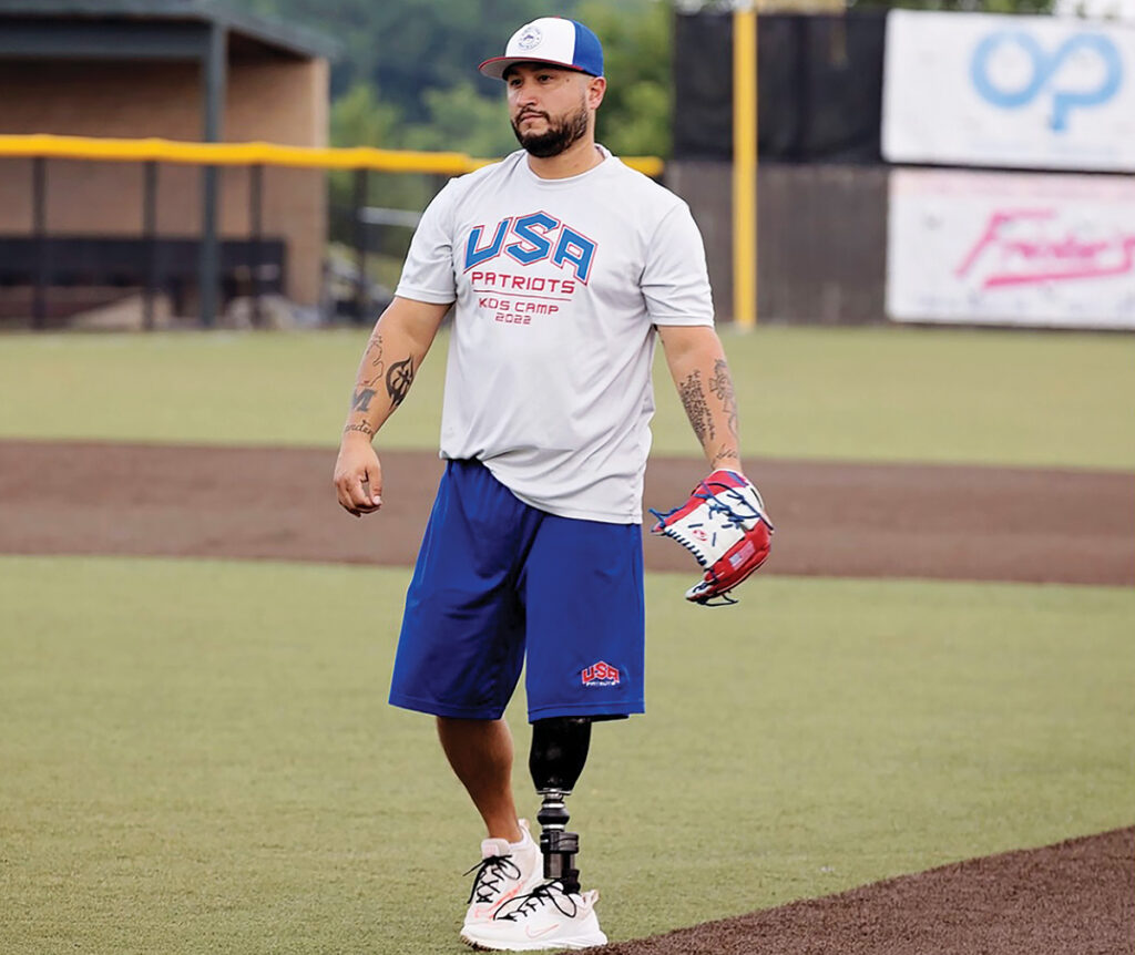 Saul Bosquez is pictured during the USA Patriots softball team’s alumni camp at Adrian College in 2022. The USA Patriots are a team made up entirely of athletes — mainly combat veterans — who have had a limb amputated. In addition to traveling the country playing games against able-bodied teams, the USA Patriots host two camps for kids every year. (Photo by R. Price Photography)