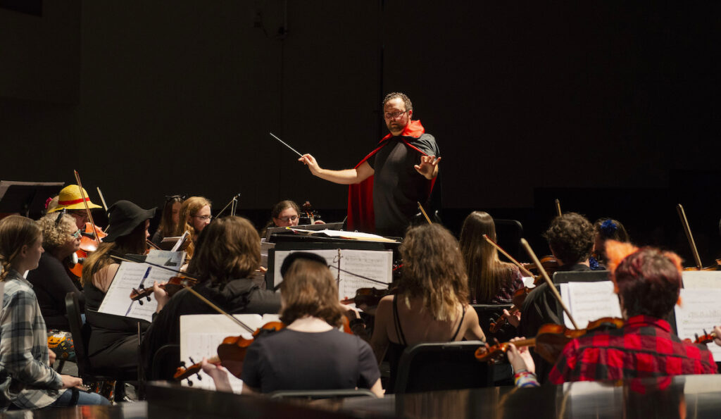 Phillip Clark conducts the Adrian College Orchestra during last year’s Halloween Concert.