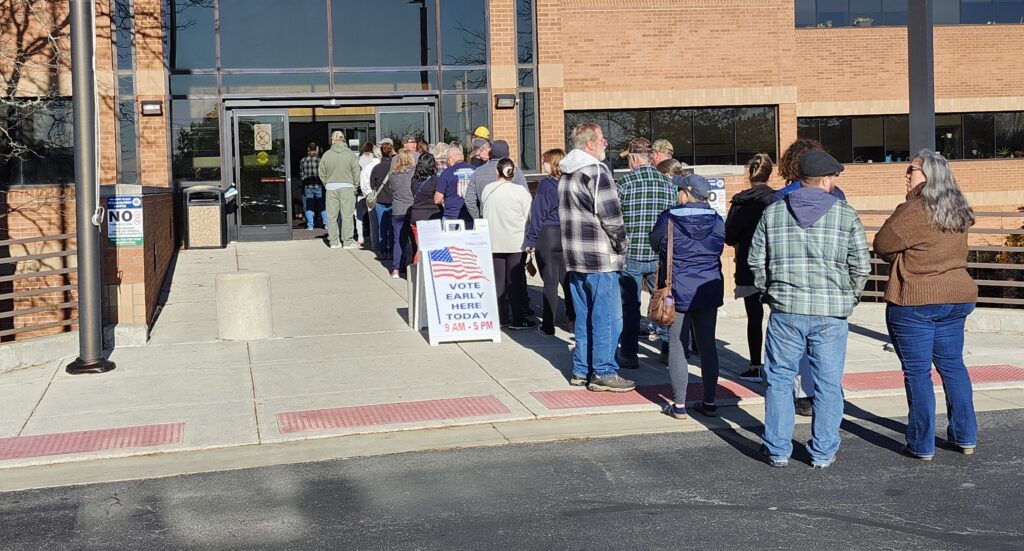 People line up for the first day of early voting on Oct. 26 at the Lenawee County Human Services Building.