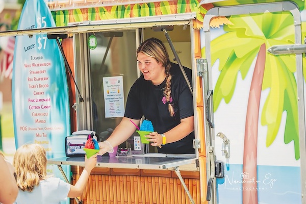 Hannah Stepp serves a customer at Hannah’s Hawaiian Shaved Ice, which she started when she was still in high school. (Photo courtesy of Hannah Stepp)