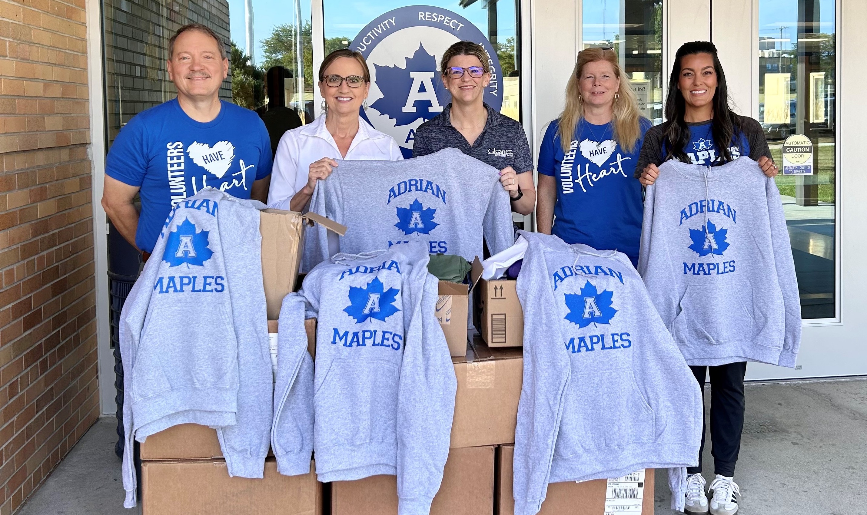 Members of Gleaner Life’s Legacy Arbor service club (from left) Mark Lenz, Liz Greenwell, Elly Sager and Christine Zeller deliver supplies to Angela Pooley, coordinator of the Families in Transition program located at Adrian High School.