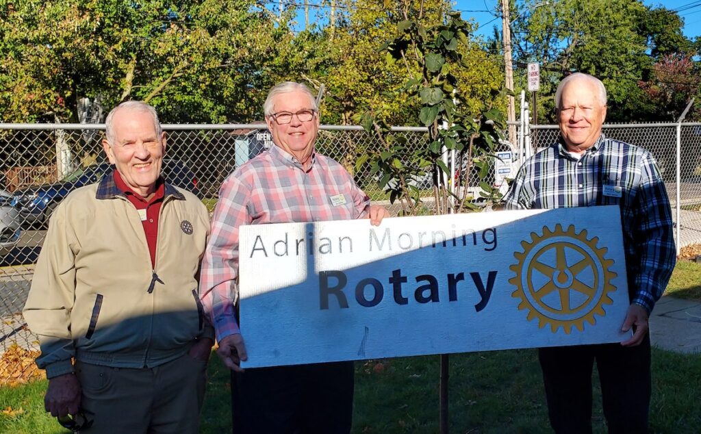 Dave Maxwell, Jim Hartley and Rich Donner, three of the charter members of the Adrian Morning Rotary Club, are pictured during a recent tree planting at Adrian Community Preschool. The club marked its 25th anniversary this year. (Photo by Julie C. Clemes)