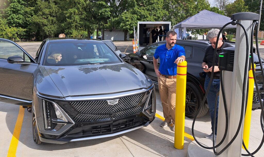 Andrew Pickford of Creek Enterprise demonstrates an electric vehicle charging station during a recent open house. The Adrian-based company, which has locations in seven states, is expanding into EV charging infrastructure. (Photo by Arlene Bachanov)