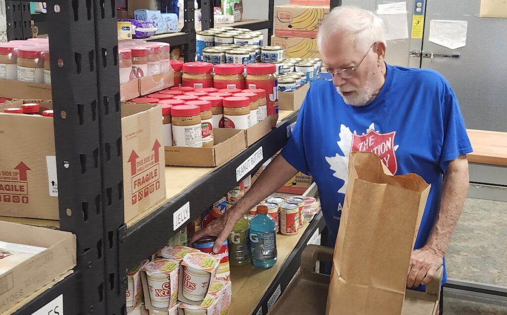 Volunteer Bob Ulrich works in the Salvation Army’s newly renovated food pantry, packing bags to be distributed to local families.