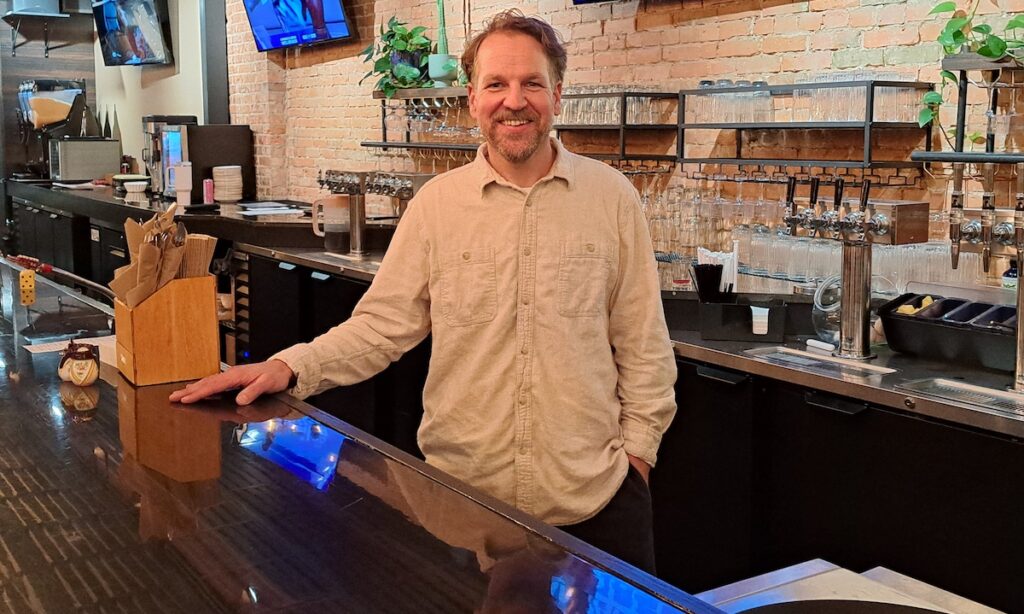 Josh Roth stands behind the bar at Maumee Street Taproom + Kitchen. The restaurant is a collaboration between two local companies: the Musgrove + Co. coffee shops, and catering company Three Dudes & Dinner.