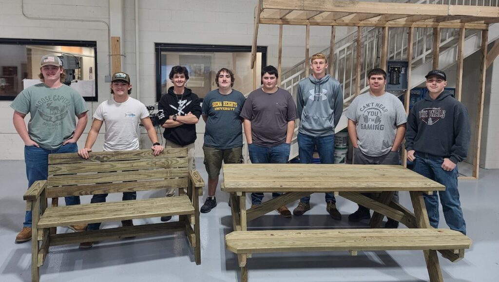 Pictured from left to right are LISD Tech Center building trades students Braeden Hall (Sand Creek), Joshua Thomas (Adrian), Elijah Crete (Madison), Harrison Mapstone (Blissfield), Mason Nichols (Blissfield), Alex Anspach (Britton Deerfield), Hunter Hallock (Adrian), and Aston Jones (Hudson).