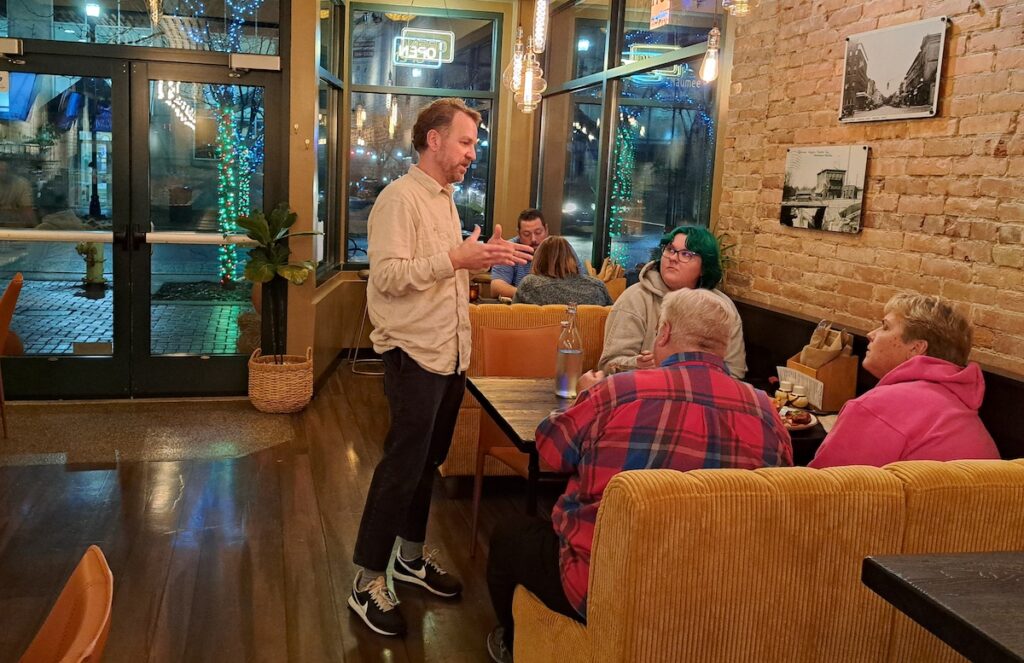 Josh Roth talks with customers at Maumee Street Taproom + Kitchen, which opened recently at the corner of Maumee and Main streets in downtown Adrian. (Photo by Arlene Bachanov)