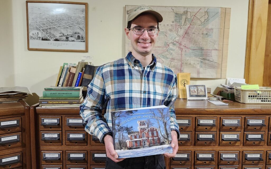 Paul Plassman is pictured at the Lenawee County Historical Museum with his book, "Southern Michigan's Castles, Churches and Courthouses."