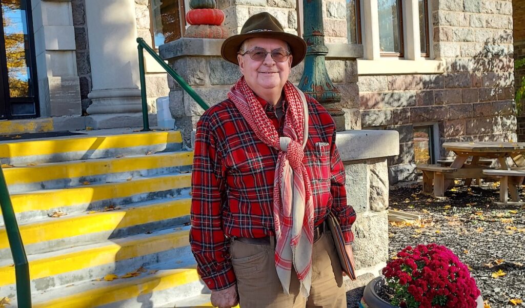 Rodney Cole is pictured at the Hudson Carnegie District Library wearing his shemagh, a large wool scarf that’s part of his winter driving preparedness kit. (Photo by Julie C. Clemes)