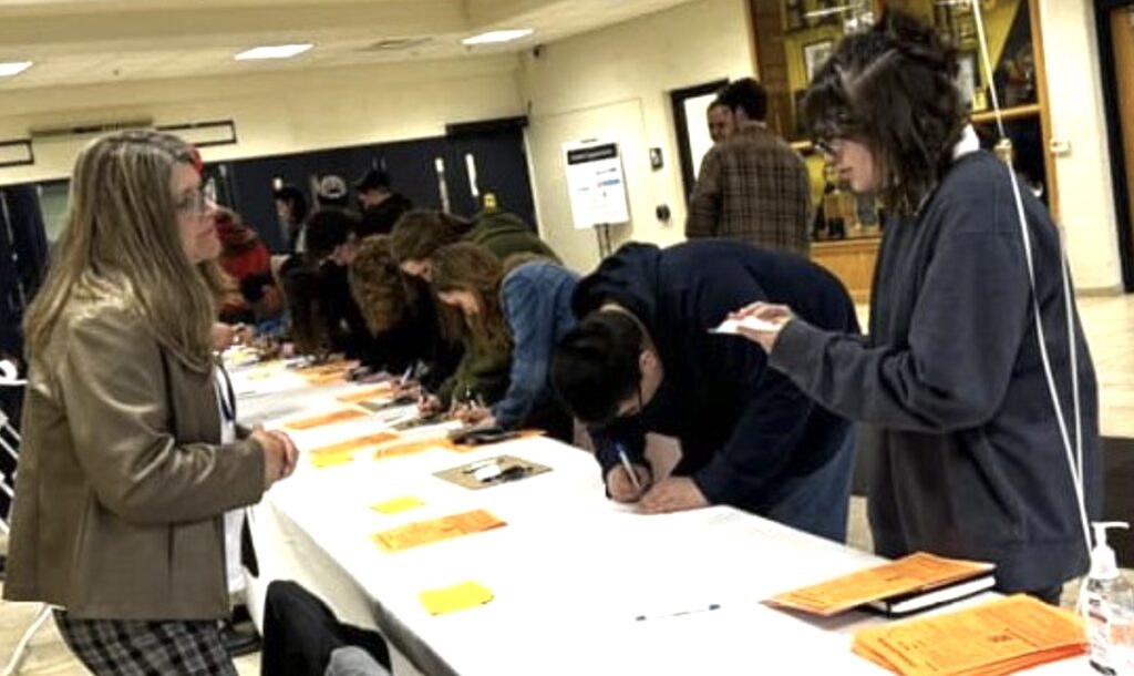 Kim Dusseau from the Lenawee Intermediate School District checks in guests at the 2023 Career Connections fair.