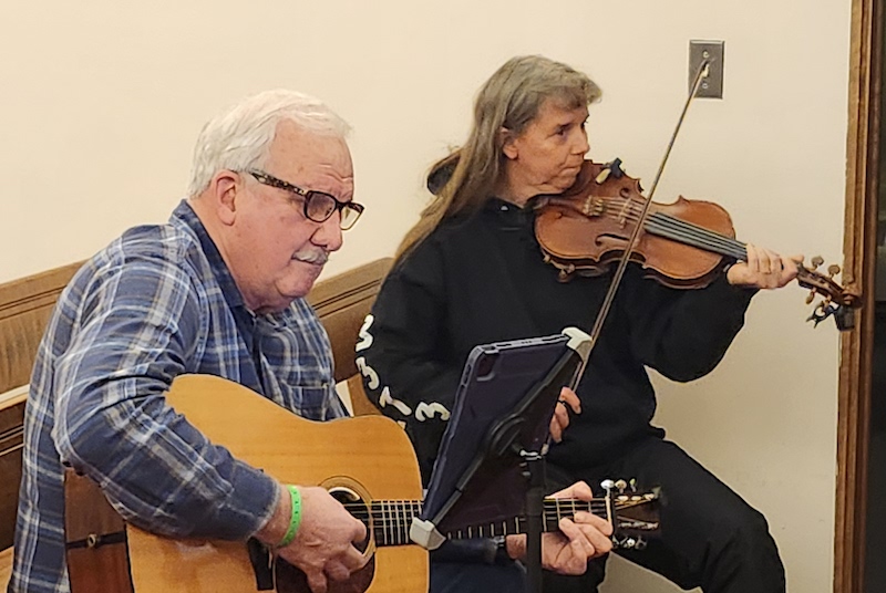 Brian Szuch of Jackson and Dixie Andres of Blissfield play a song during the Maumee Street Jam on Jan. 11.