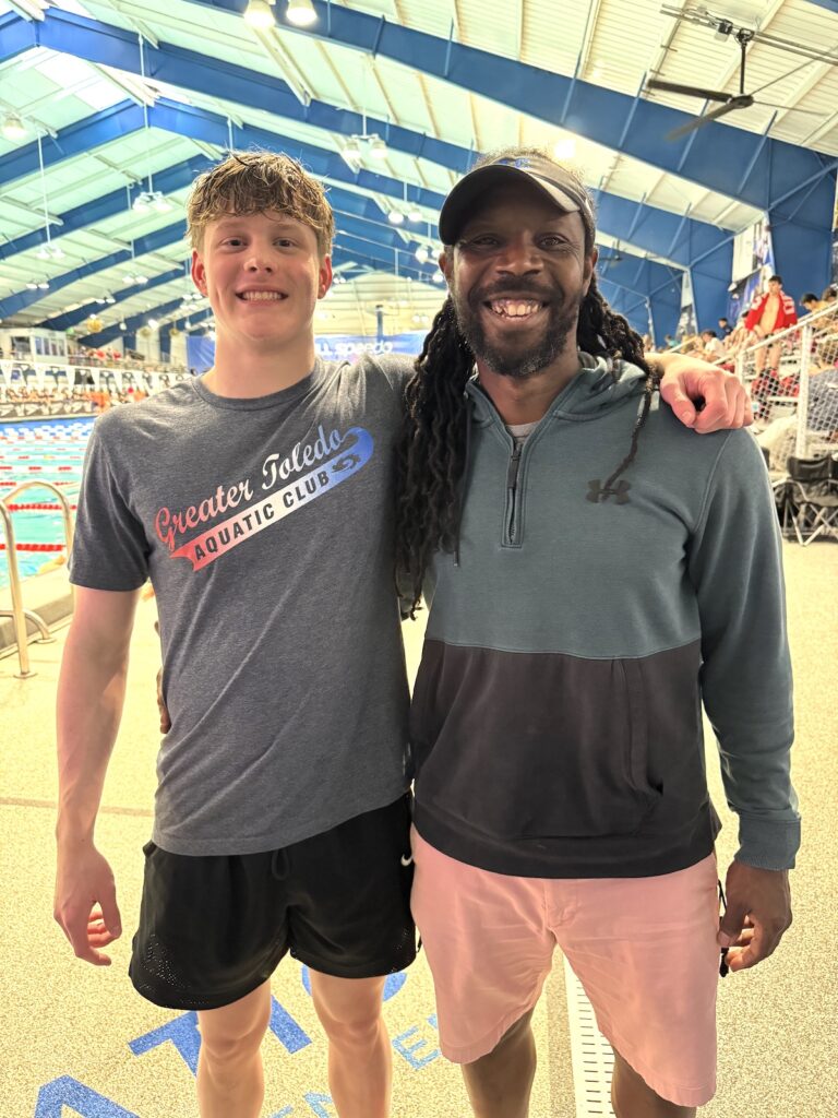 London Rising, an Adrian High School junior, is pictured with coach Brent Ransom of the Greater Toledo Aquatic Club at the NCSA Spring Championships in March in Orlando.