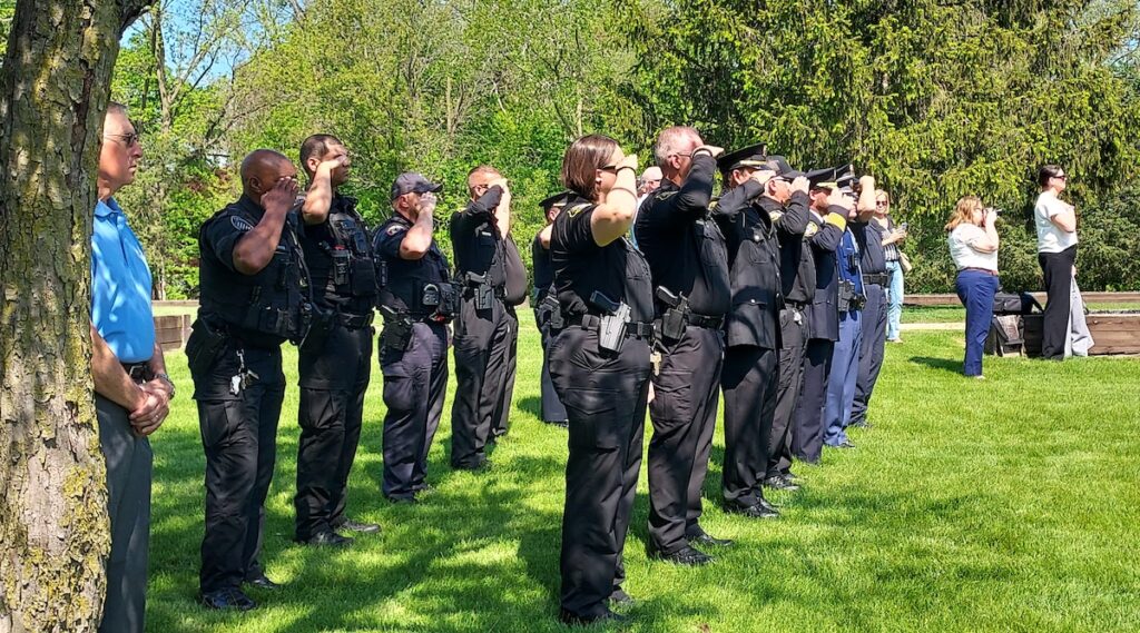 Local law enforcement officers salute during a memorial ceremony on May 15 for officers who died in the line of duty. (Photo by Julie C. Clemes)