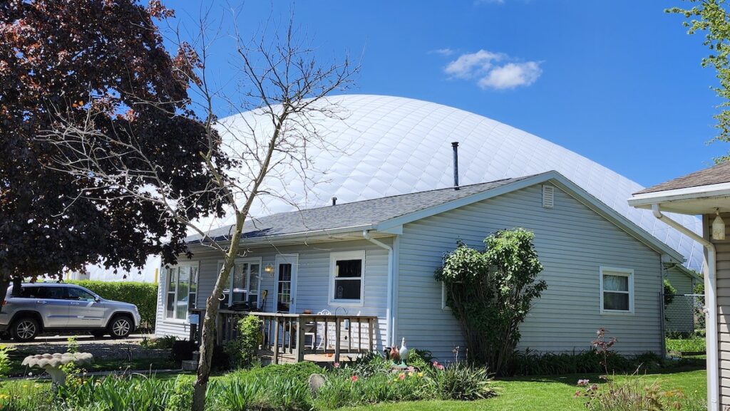 The new Adrian College sports dome is seen on May 8 behind a home on Shrewbury Avenue.