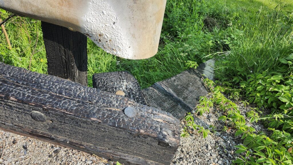 Fire damage can be seen along the structure of the Beecher Road bridge over Saint Joseph Creek.