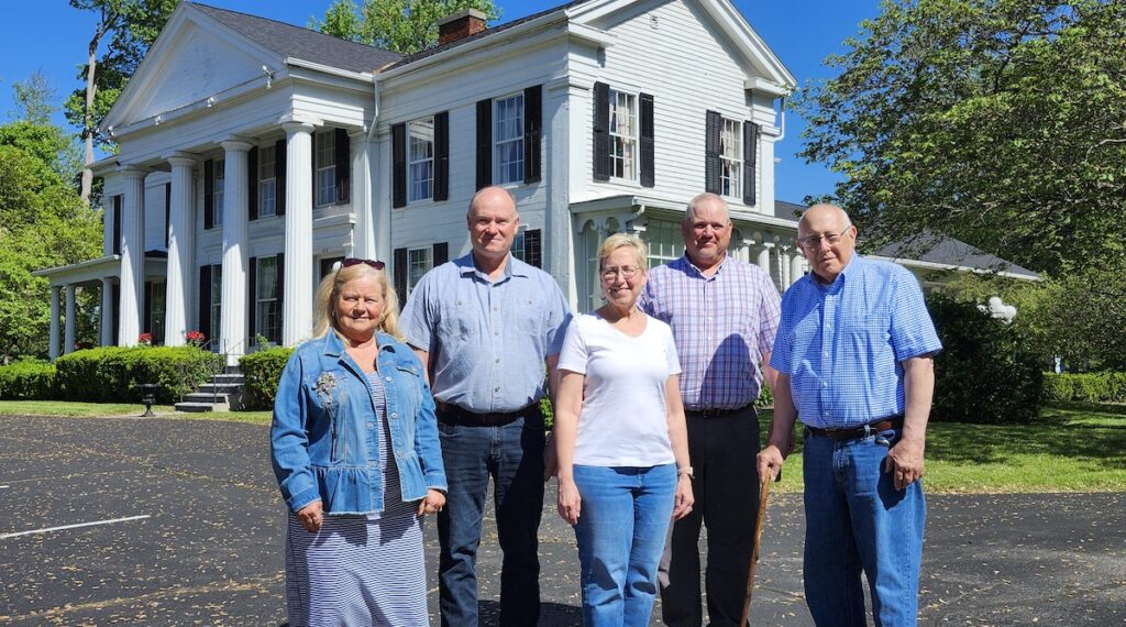 Pictured in front of the Hathaway House in Blissfield are American Farm Museum and Education Center board members Londa Pickles, Randy Brenke, Melissa Tsuji, Ted Mason, and Pete Durbin.