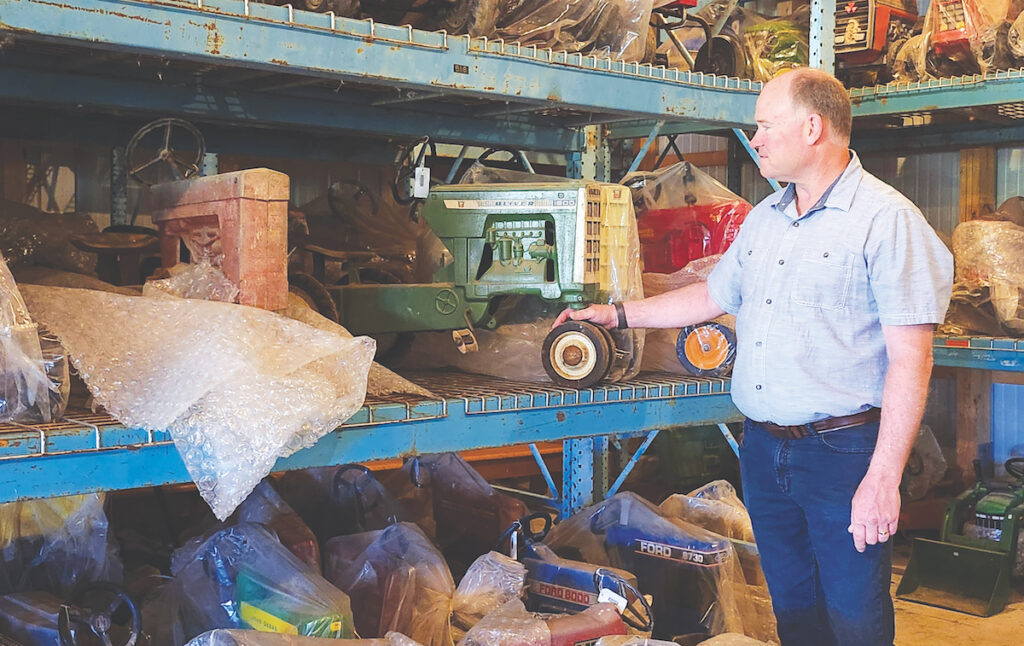 Randy Brenke, a board member of the American Farm Museum and Education Center, shows a portion of the Charles and Barbara Burkholder Farm Toy Collection, which will be displayed in the former Hathaway House restaurant in Blissfield.