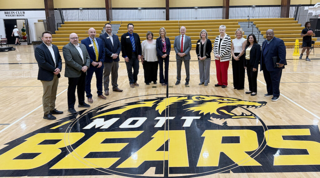 Mott Community College president Shaunda Richardson-Snell and Adrian College president Jeffrey Docking (center) pose with staff after signing an articulation agreement. (Photo courtesy of Adrian College)