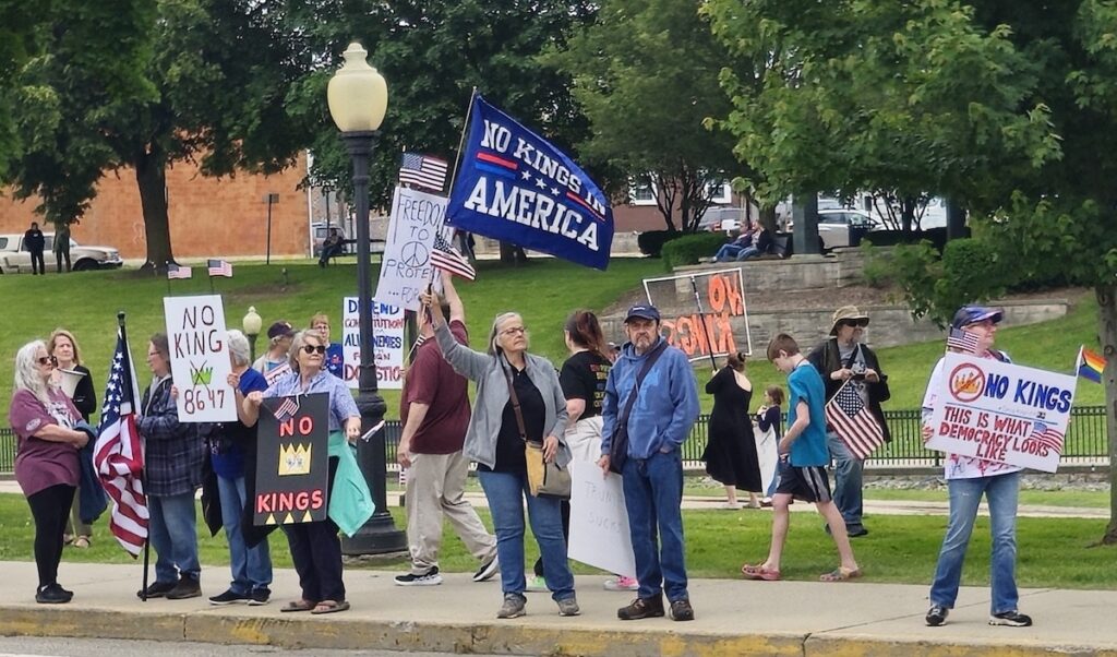 A "No kings in America" flag was among the banners being carried at a June 14 protest in Adrian.