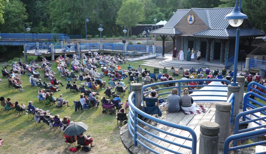 Theatergoers surround the bandshell at Trestle Park for the Adrian Shakespeare Company’s debut production, “A Midsummer Night’s Dream,” in 2024. (Photo by Lad Strayer)