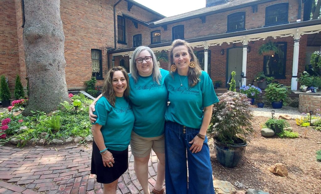Kim Freeman, Serena Riley and Danielle Ward are pictured outside the Stacy Mansion in Tecumseh, which they renovated and brought back to life as an inn and event center. (Photo by Julie C. Clemes)