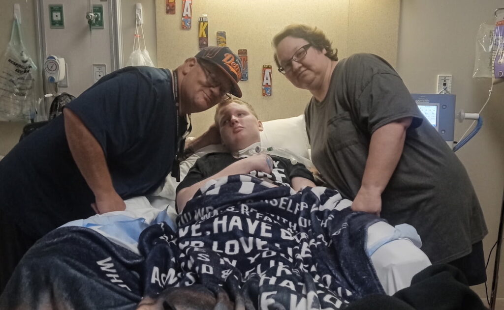 Dakota Courington is pictured recently with his dad, Jack, and mom, Carrie. Dakota, 16, was hit by a car while riding his bike a year ago. (Photo courtesy of the Courington family)