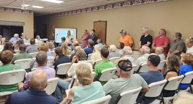 Marla Korpar of solar power company Orsted speaks in front of a packed crowd at the Deerfield Township Hall on Aug. 13. (Photo by Erik Gable)
