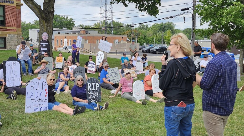 Judith Hammerle of Adrian and Scott Hendrickson of Tipton speak during a "die-in" protest on Aug. 23 at the Lenawee County Courthouse.